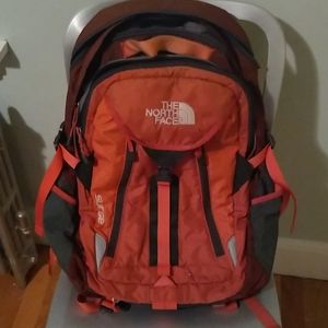 Orange north face surge backpack